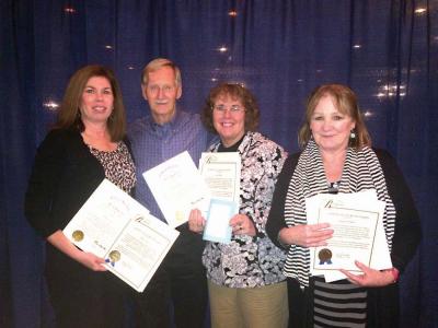 Mary Grow, John Miles, Jean Medico and Bridget O’Hara pose for a photo with their commendations from Mayor Martin Walsh, City Councillor Frank Baker, and “favorite first responder notes” from Miles on Monday. 	Lauren Dezenski photo
